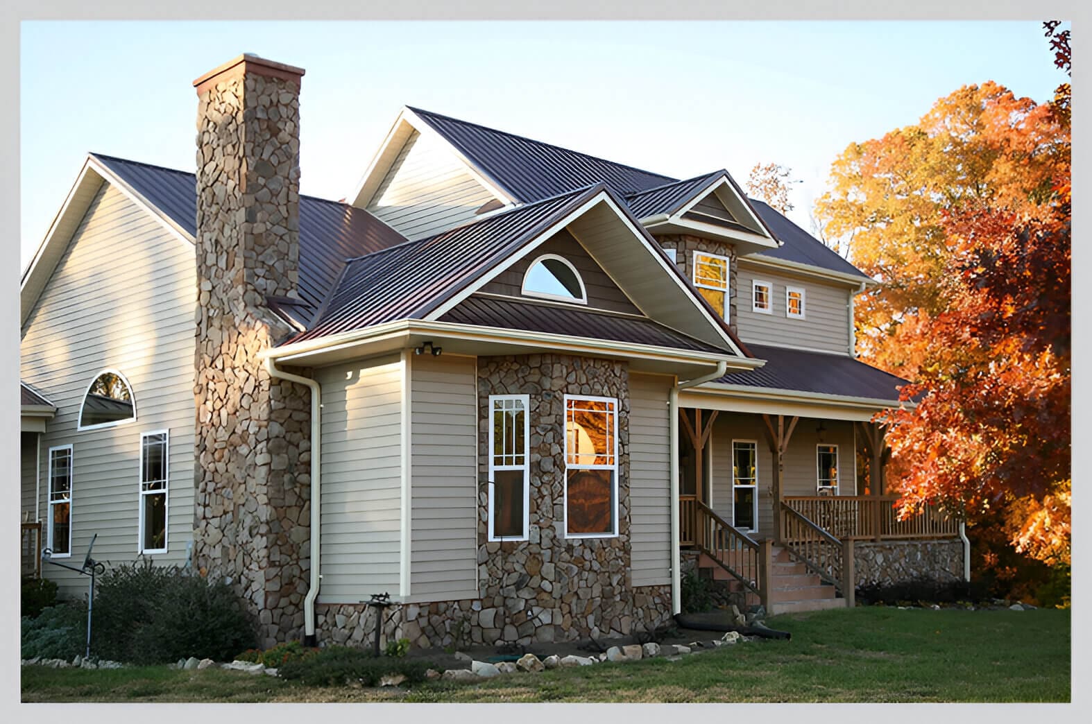 A house with a brick chimney and stone front.