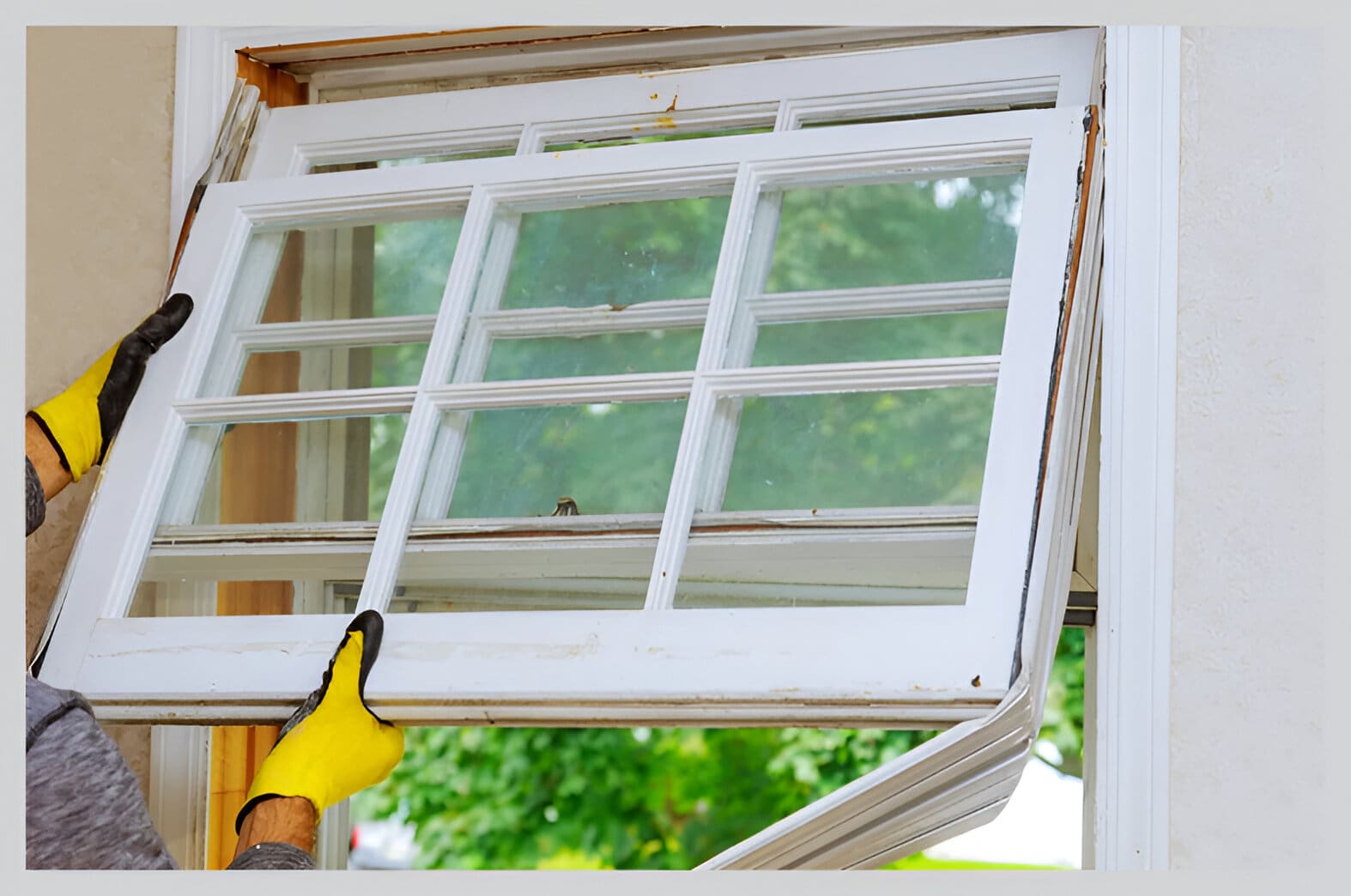 A person is pointing to an old window.