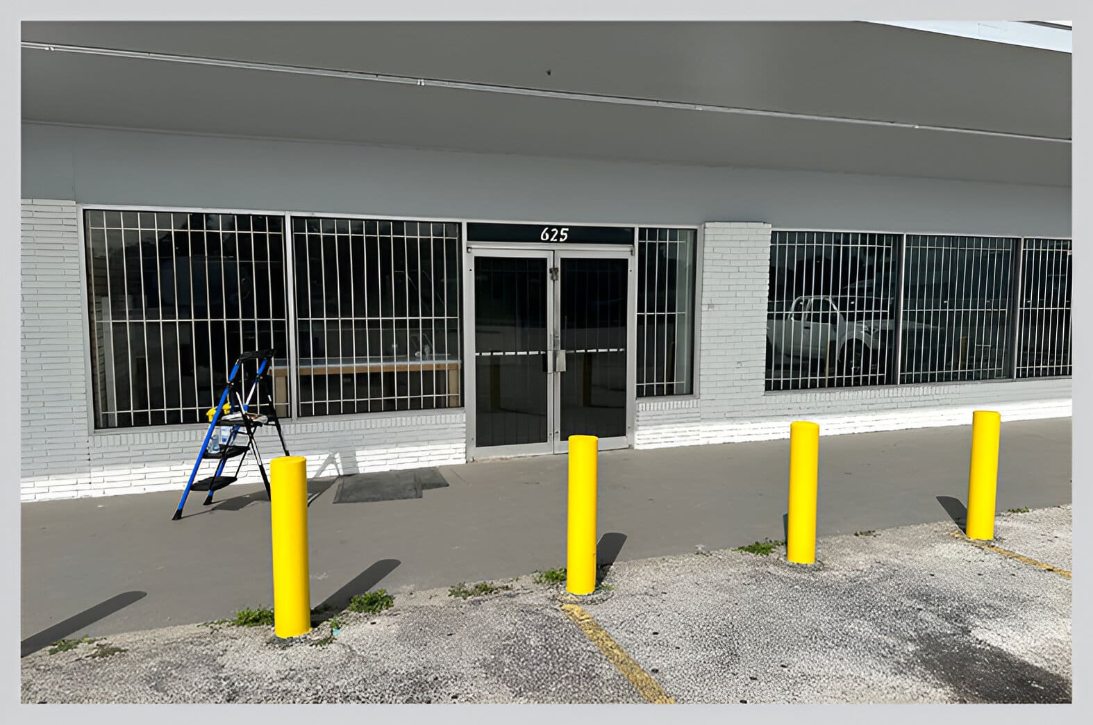 A building with yellow posts in front of it.