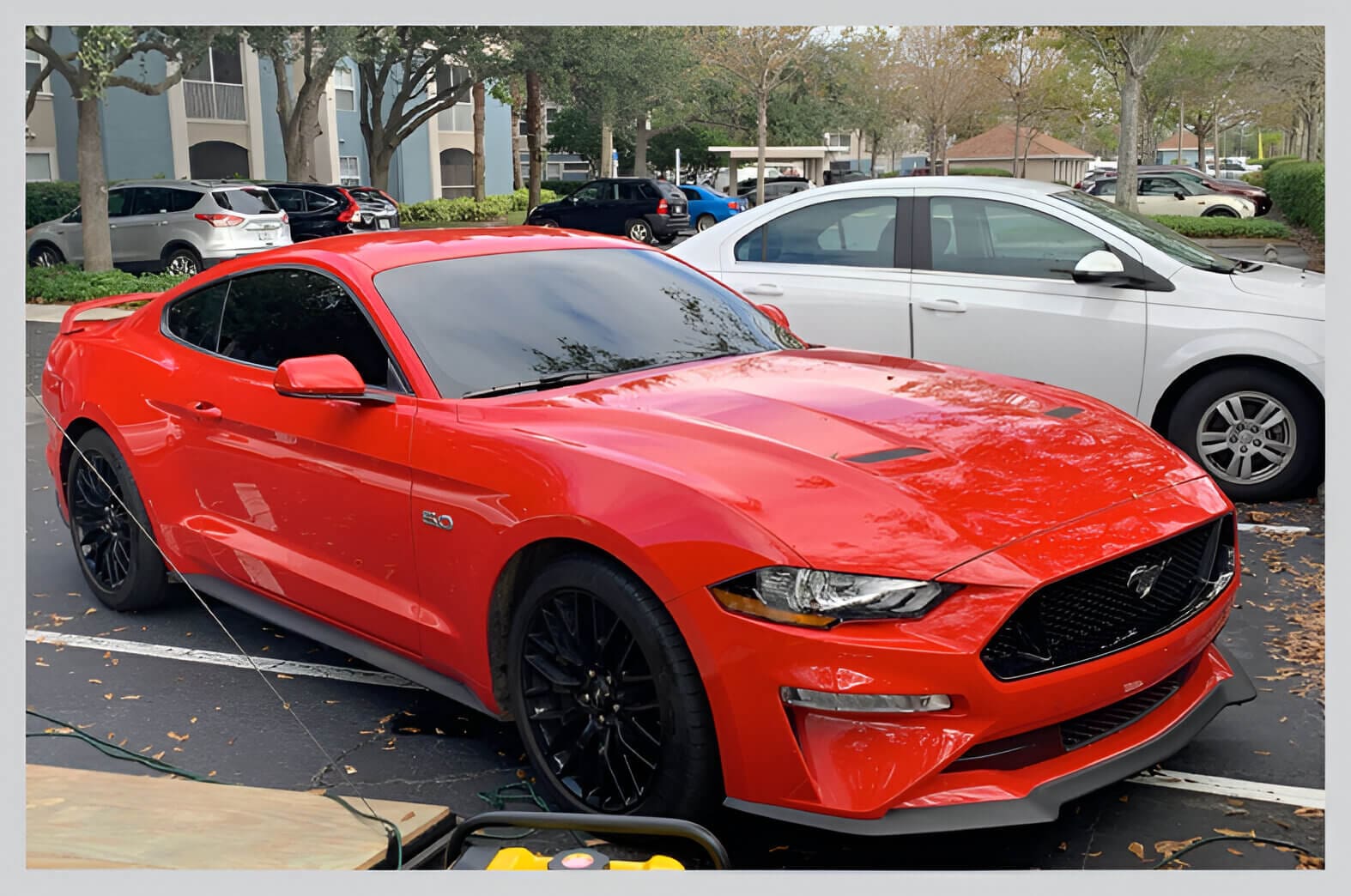 A red car parked on the side of a road.