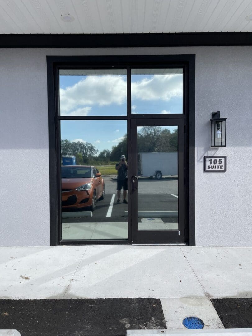 A car is parked in front of the door.